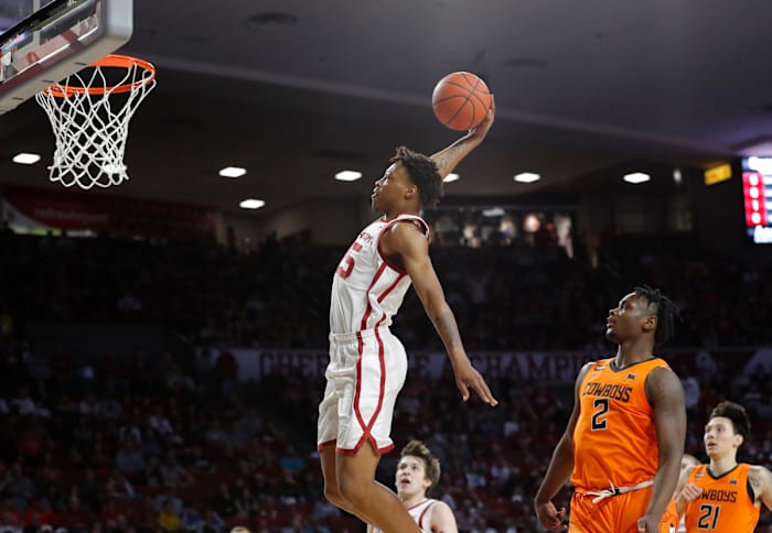 Oklahoma Sooners guard Alondes Williams (15) dunks as Oklahoma State Cowboys guard Chris Harris Jr. (2) looks on during the first half at Lloyd Noble Center.